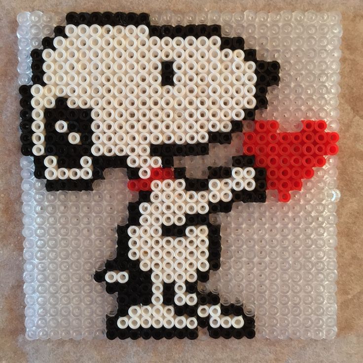 the bead art is made to look like an image of person holding a red heart