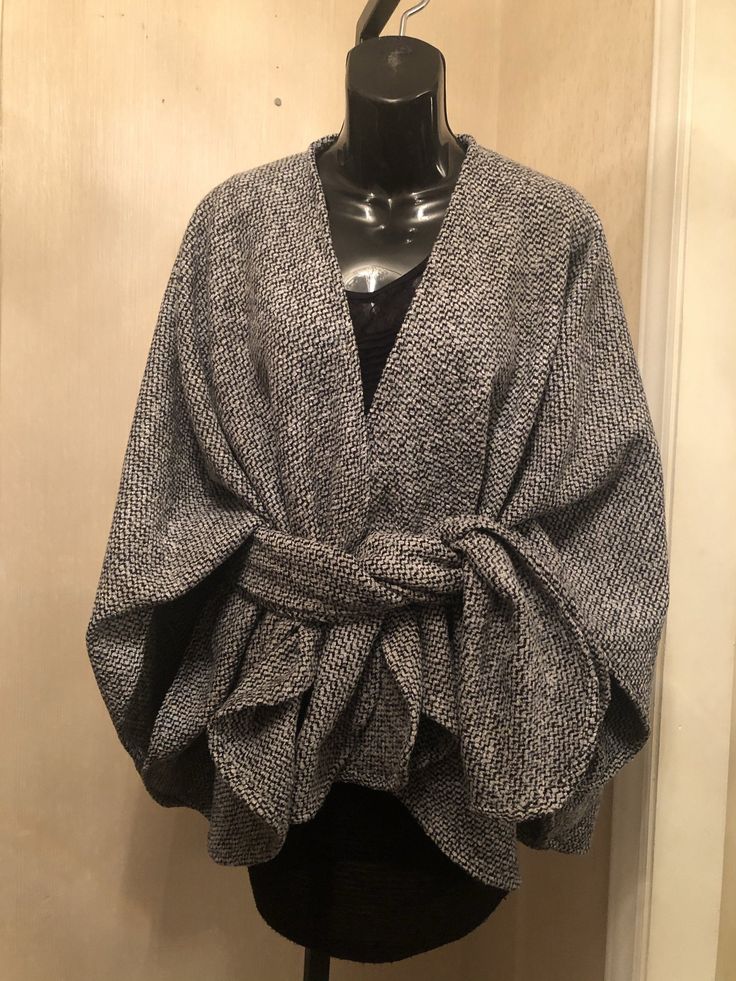 Wool and polyester blend Boucle Crop length Classic wrap with signature matching scarf. Handcrafted, Dry clean Elegant Fall Poncho For Workwear, Elegant Fall Poncho For Work, Elegant Fall Workwear Poncho, Gray One Size Fall Cape, Elegant Cardigan For Cold Weather, Black Scarf For Fall, One Size Fall Cape With Scarf Detail, One Size Fall Cape With Scarf, Elegant Wool Shawl Outerwear