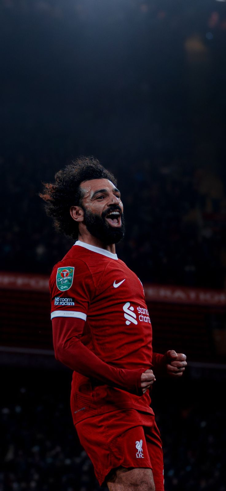 a man with a beard running on a soccer field