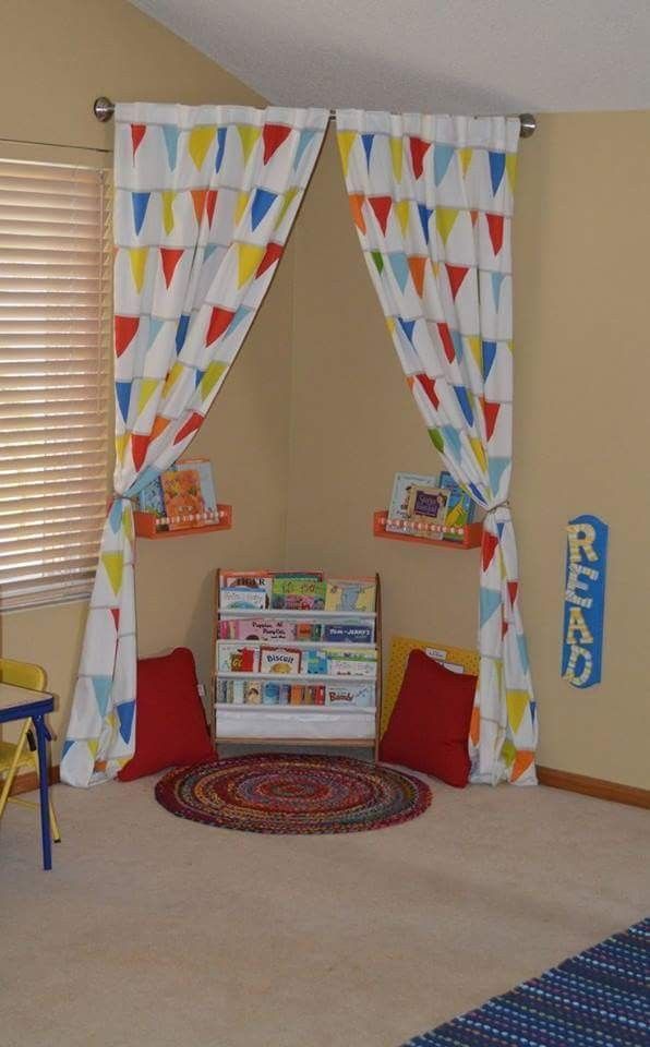 a child's playroom with colorful curtains and rugs on the floor in front of it