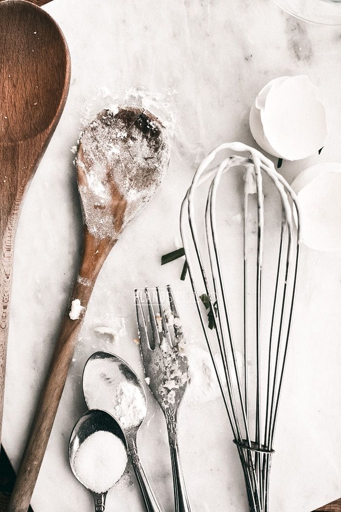 spoons, whisks and sugar on a table