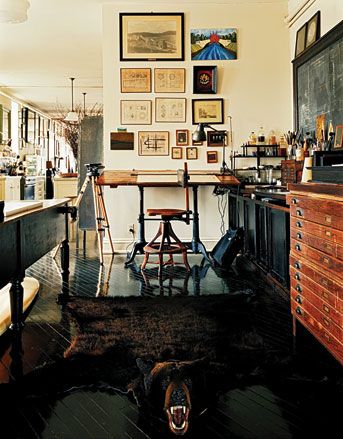 a living room filled with lots of furniture and pictures on the wall above it's bar