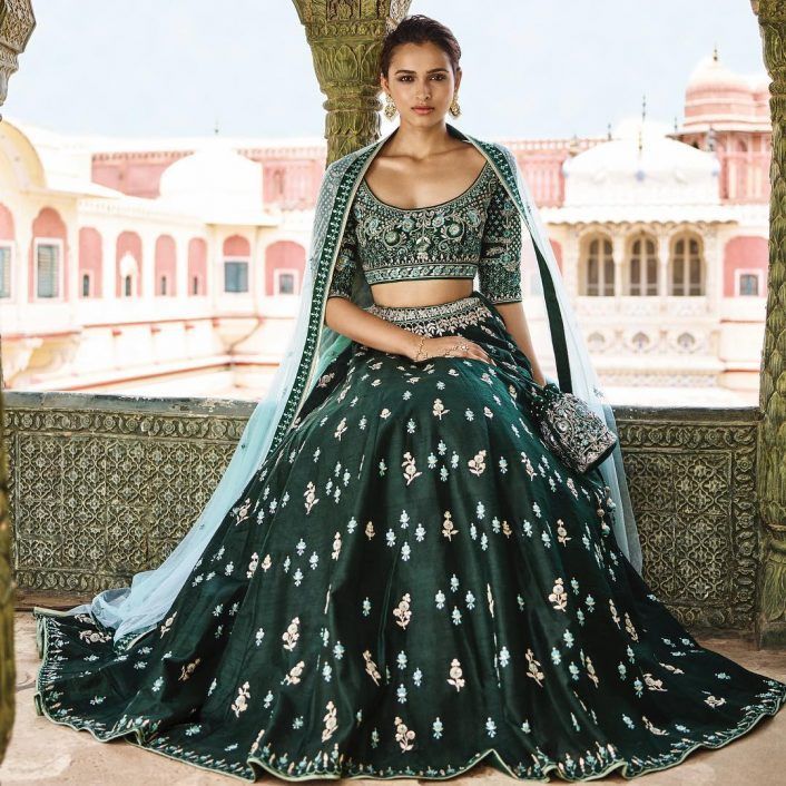 a woman in a green and white lehenga