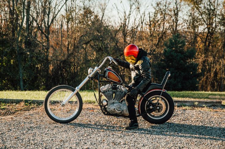 a person on a motorcycle with a red helmet