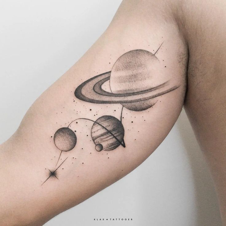 an arm tattoo with saturn and the four planets on it's left side,