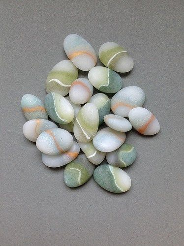 some white and green rocks on a gray surface