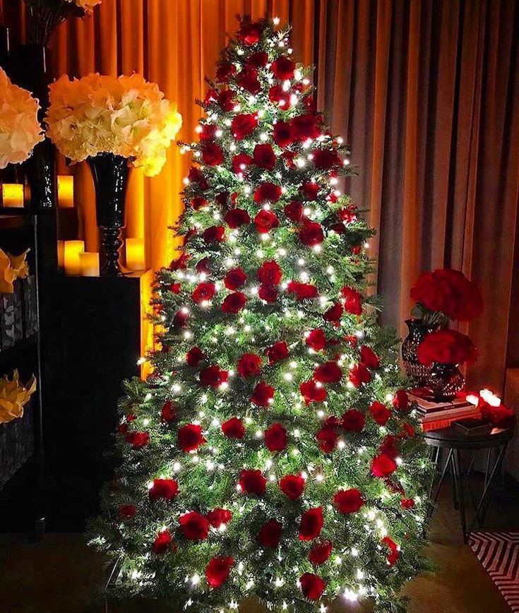 a decorated christmas tree with red and white flowers