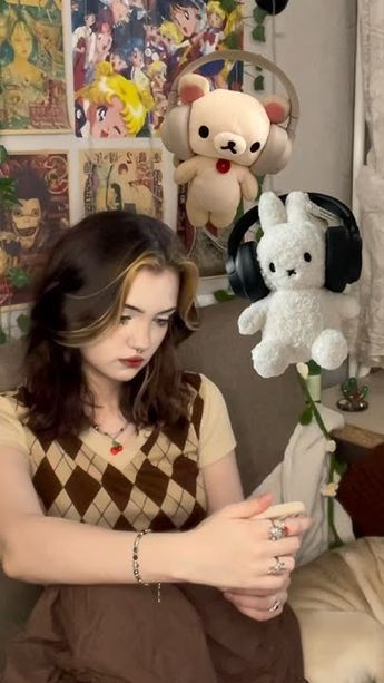 a woman sitting on a couch with stuffed animals