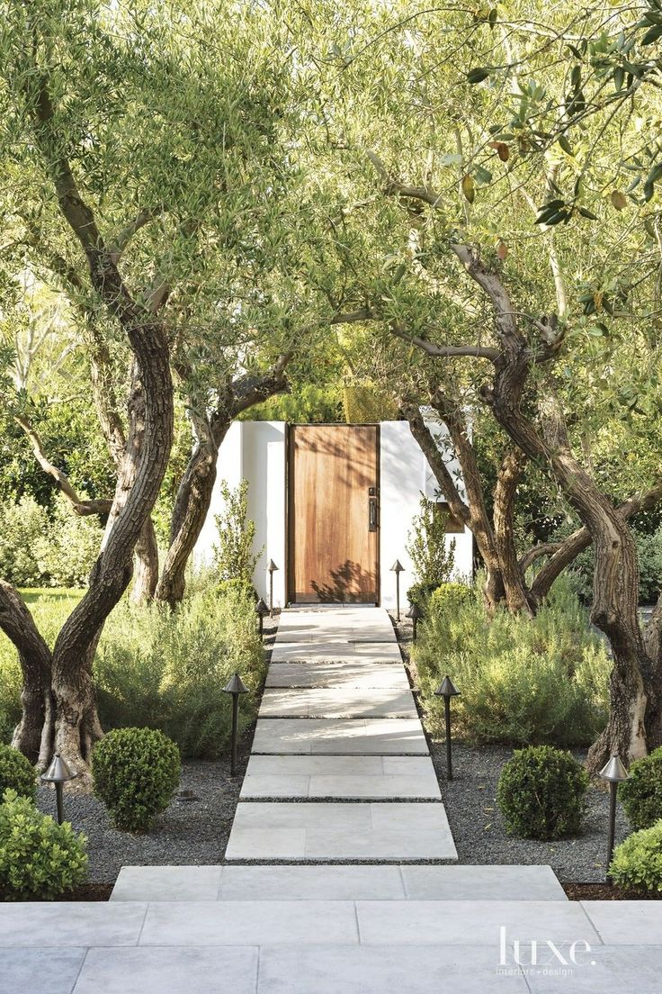 an entrance to a home surrounded by trees