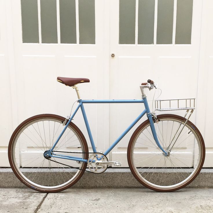 a blue bicycle parked in front of a white garage door