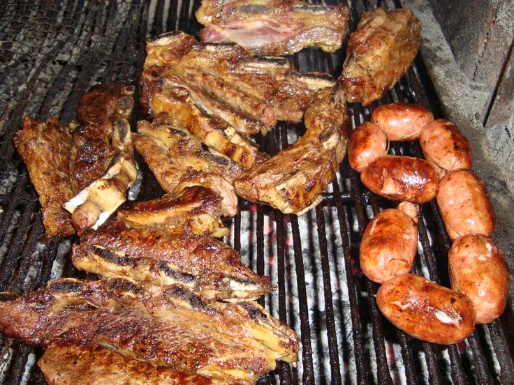 steaks and shrimp are cooking on the grill