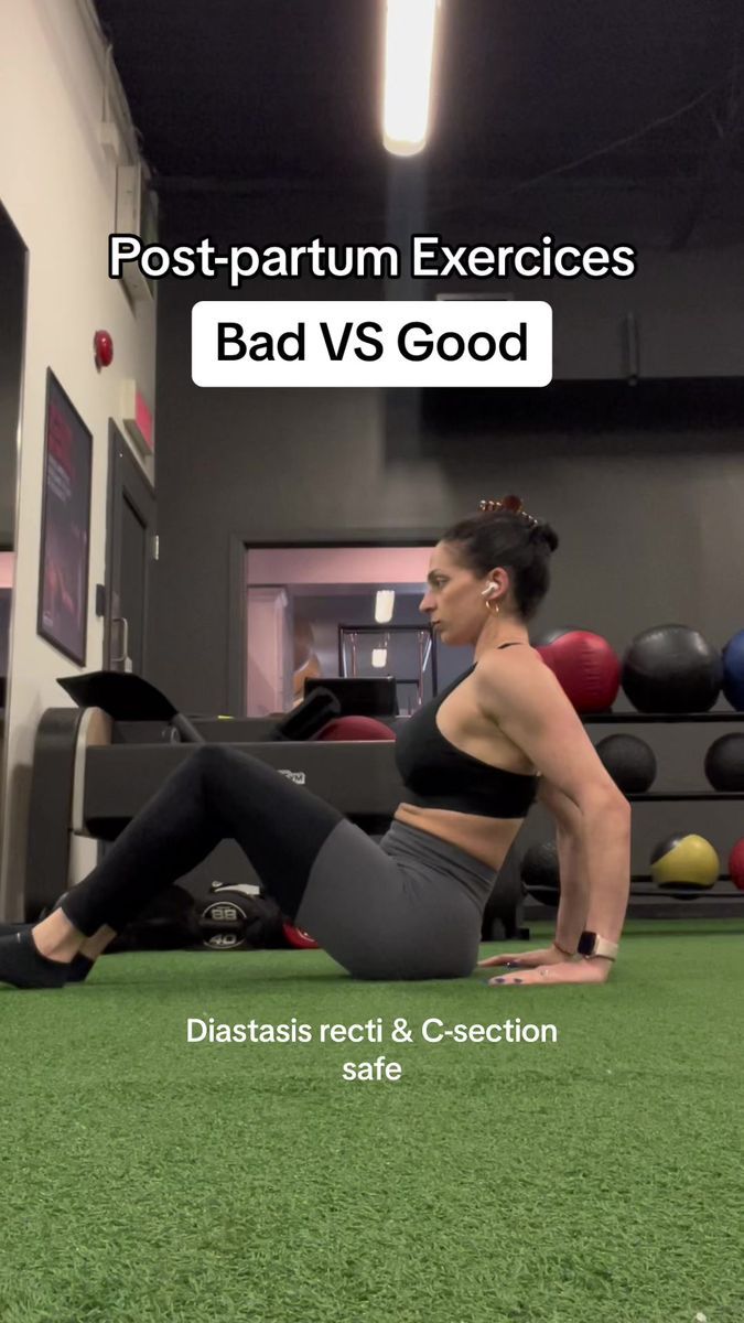 a woman is doing push ups on the ground in a gym with green turf and exercise balls behind her