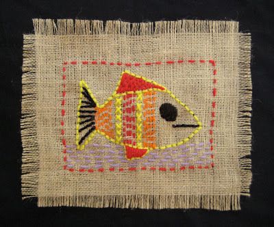 an embroidered fish on a piece of burlock