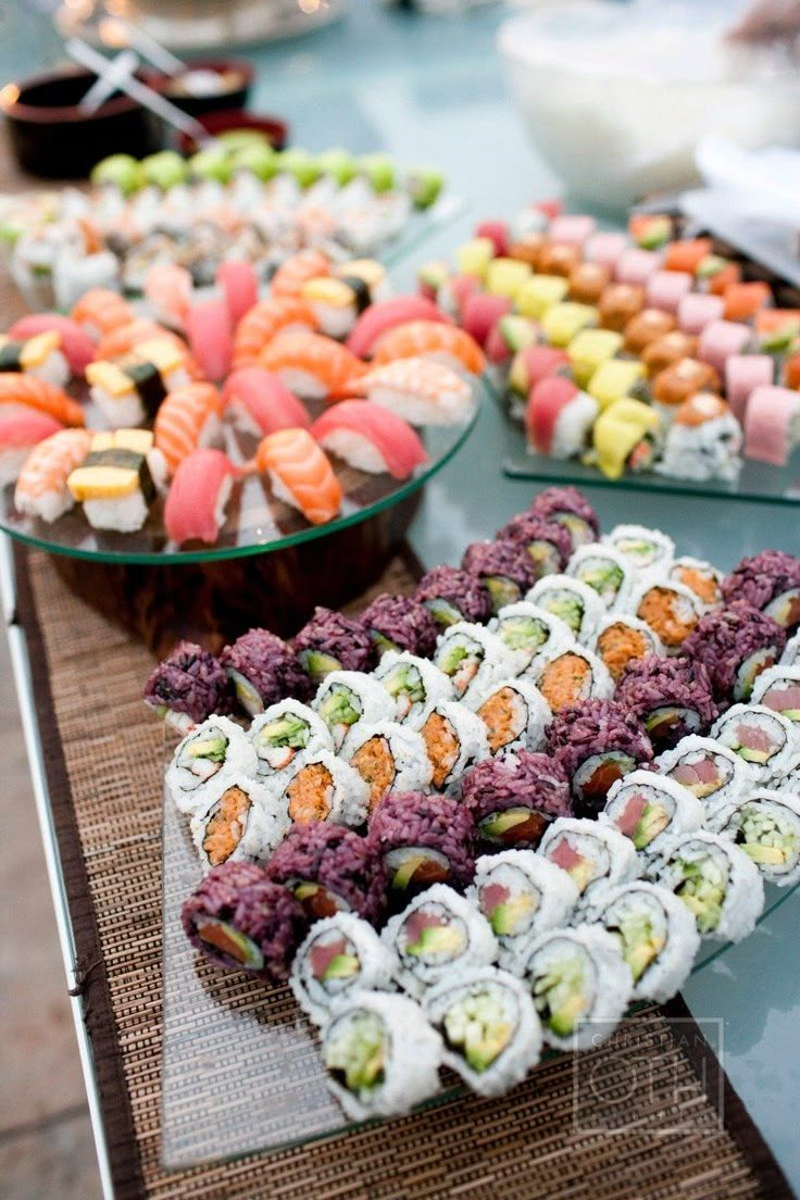 a table topped with lots of different types of sushi