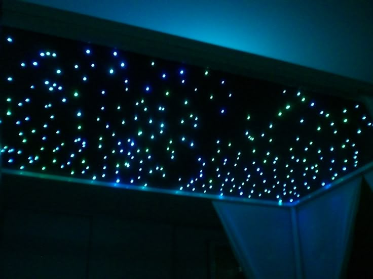 the ceiling is covered with blue and green lights in an area that looks like something out of space