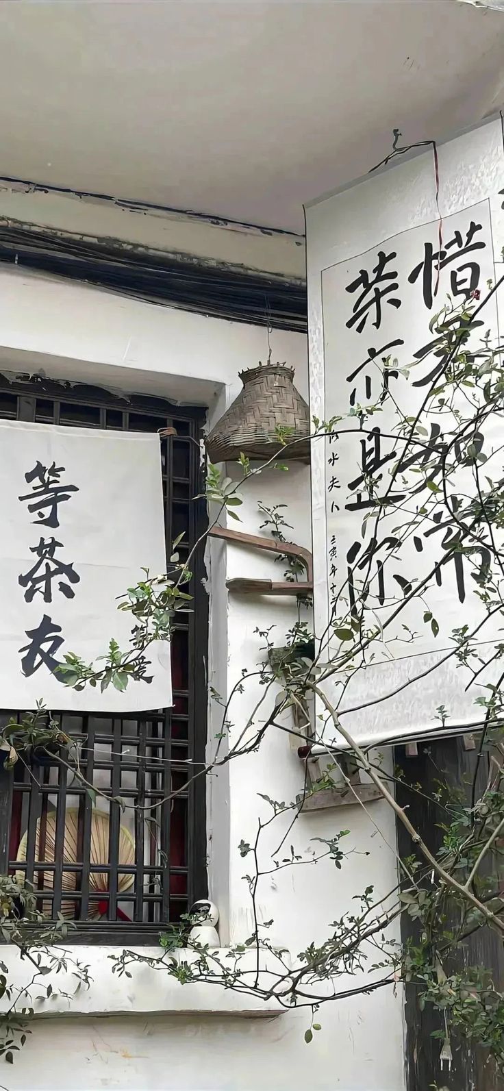 there is a sign on the side of a building with chinese characters hanging from it