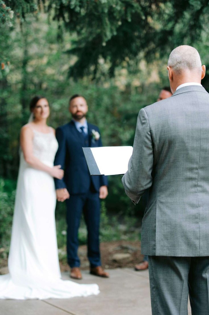 the bride and groom are getting ready to exchange their vows at this outdoor wedding ceremony