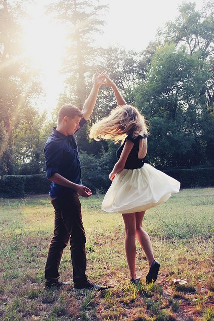 a man standing next to a woman in a field