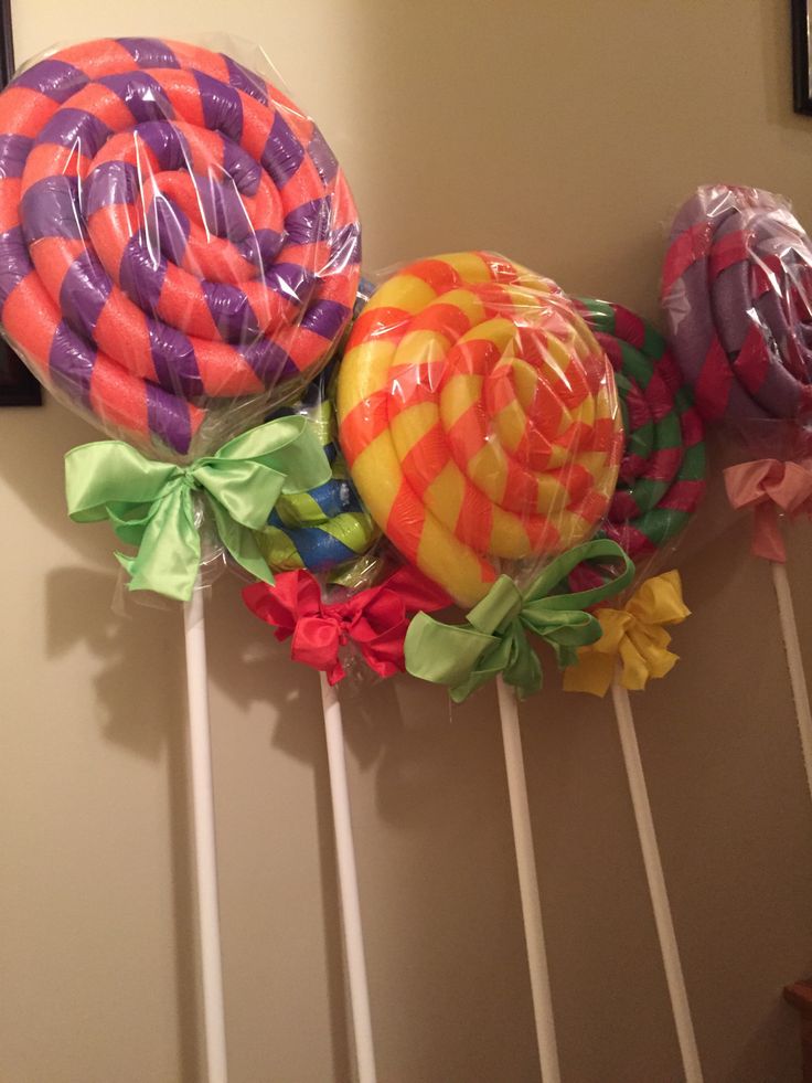 three lollipops are on top of each other and tied to the wall