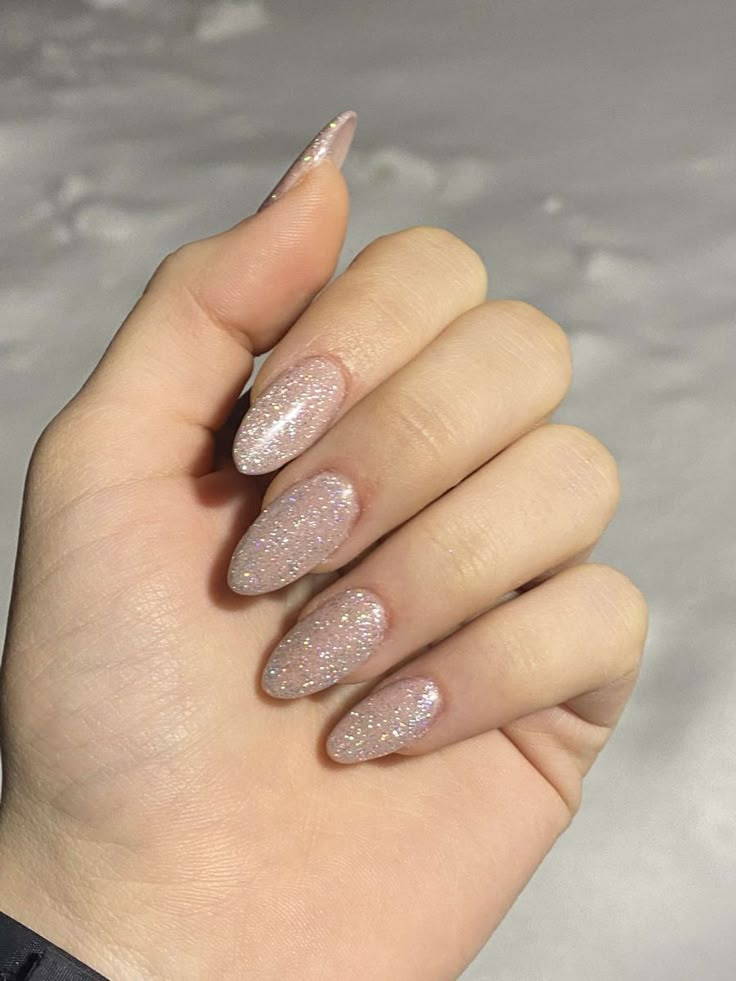 Prom Nails White And Silver Almond, Prom Nails Acrylic Classy Almond, Silver Almond Nails Glitter, White Glittery Almond Nails, Off White Sparkly Nails, Clear Sparkly Acrylic Nails Almond, Silver Sparkly Nails Almond, Sliver Almonds Nails, Nude Glitter Nails Almond