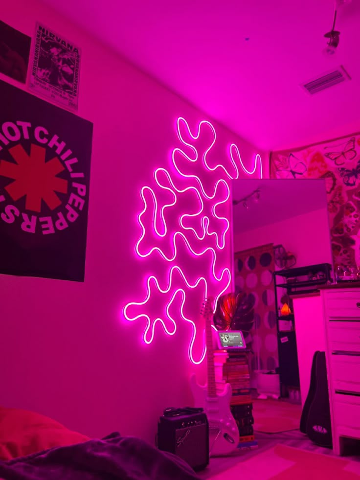 a room with pink walls and neon lights