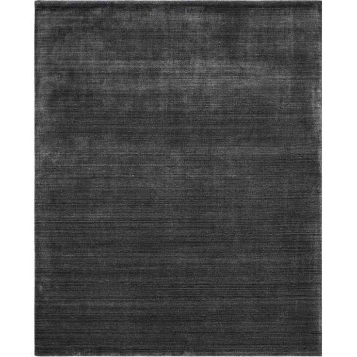 the rug is made from dark grey wool and has an uneven pattern on top of it