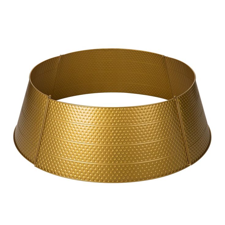 a gold colored metal bracelet on a white background with clippings to the side