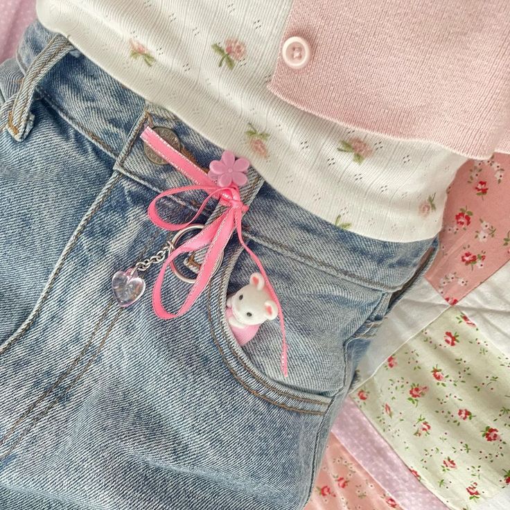 a close up of a person's jeans with a teddy bear in the pocket