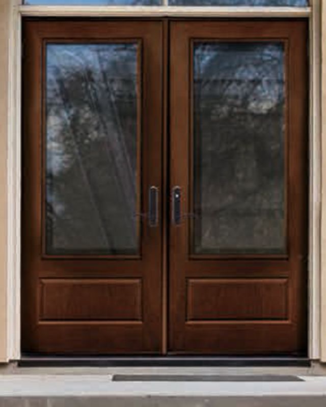 two brown double doors with glass on the outside