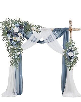 a white and blue wedding arch decorated with flowers