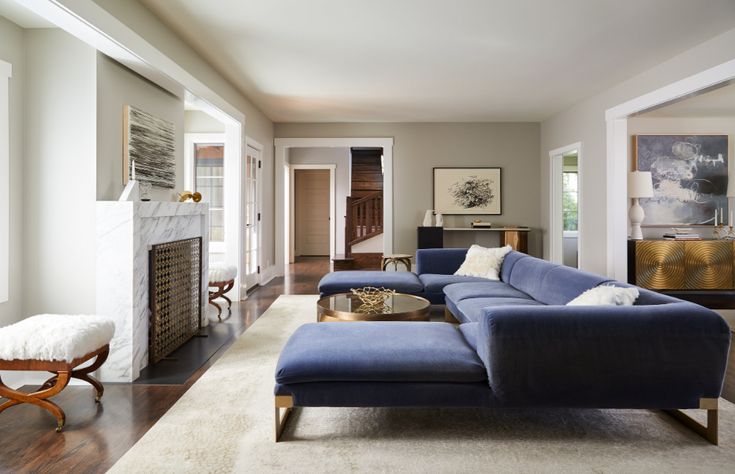 a living room filled with furniture and a fire place in the middle of a room