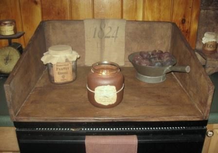 an old fashioned stove with some jars on it