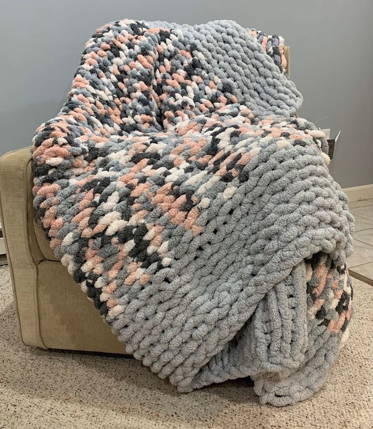 a blanket is sitting on top of a couch