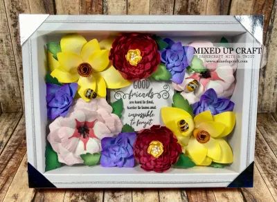 a box that has flowers in it on a wooden surface with the words mixed up craft