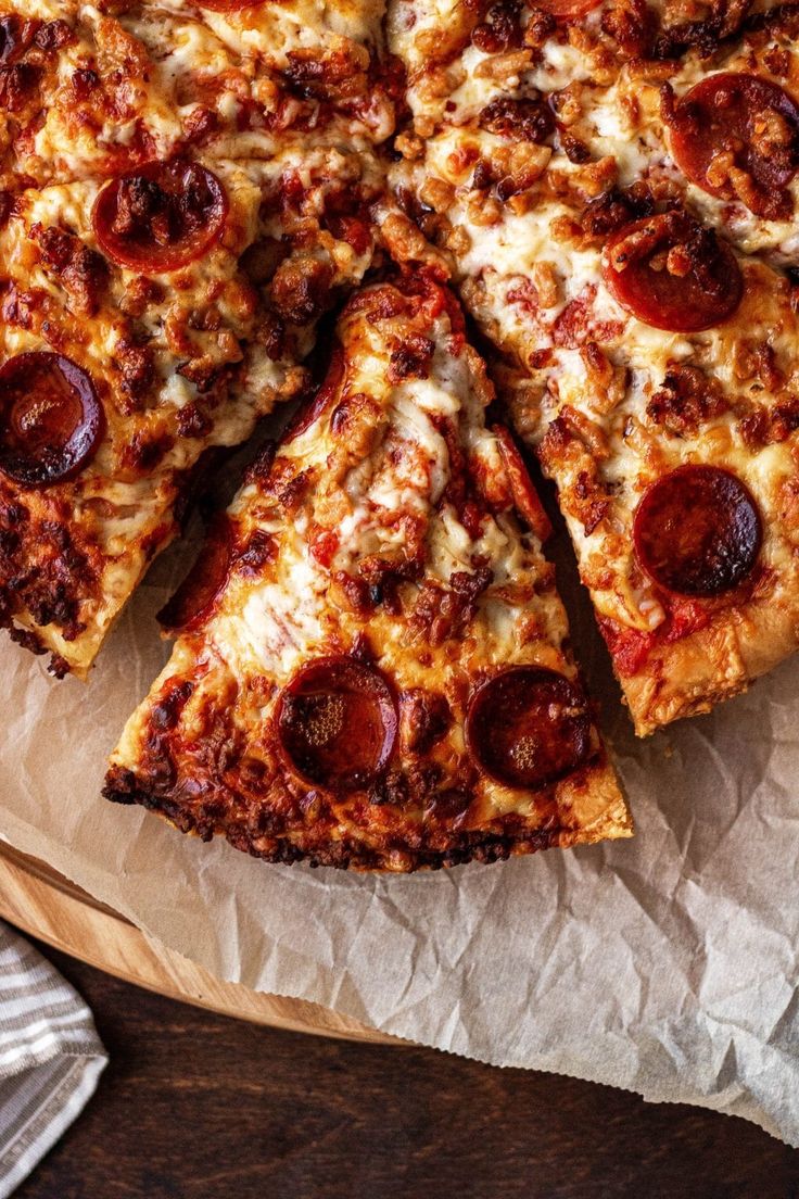 a pizza cut into eight slices on top of paper