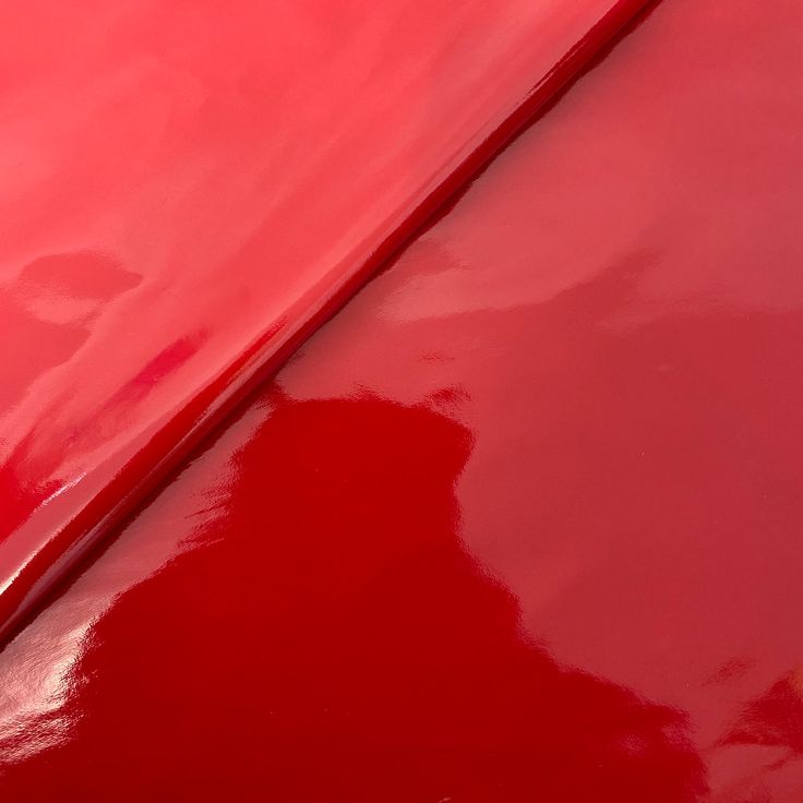 closeup of the hood of a red car