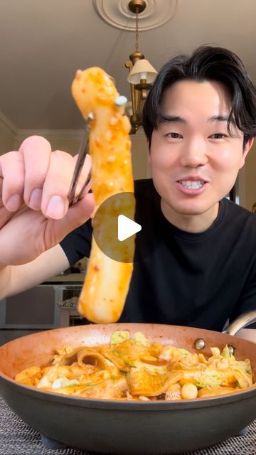 a man is eating food from a bowl with a large piece of meat sticking out of it