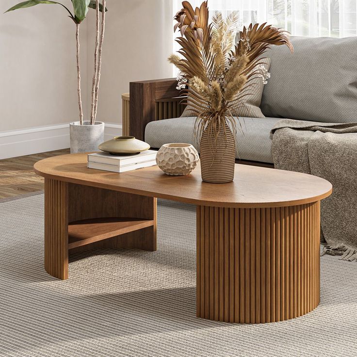 a living room with a couch, coffee table and potted plant on the floor