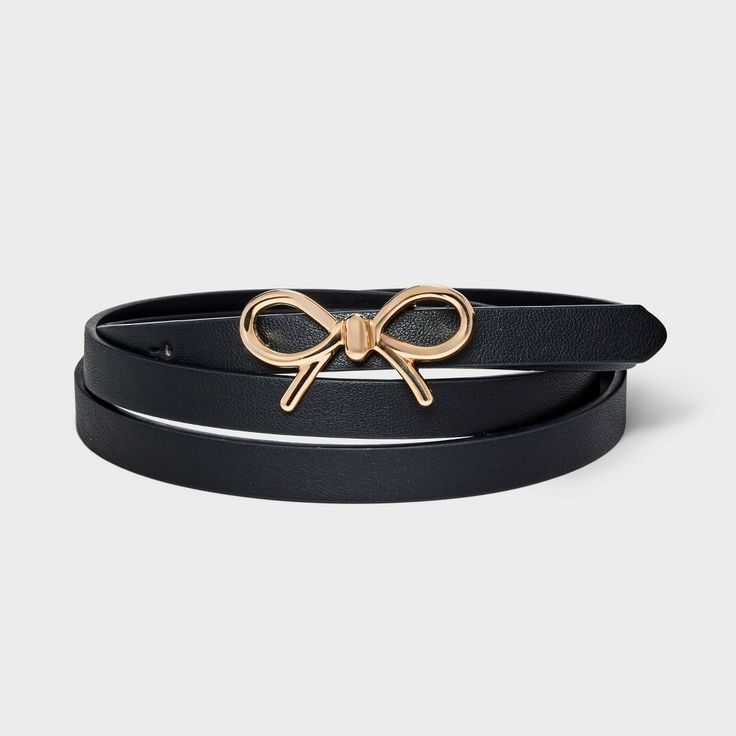 Add a sweet touch of style to any of your looks with this Bow Belt Belt from Ava & Viv™. This black belt with a slim profile features a bow-shaped metal buckle in a gold tone for a charming aesthetic. The adjustable strap offers a secure, customized fit around your waist, and it pairs well with both casual and dressy outfits. Formal Black Belts With Adjustable Strap, Black And Gold Belt, Black Bow Belt, Black Belt With Gold Buckle, Black Leather Belt With Gold-tone Hardware, Womens Leather Belt, Bow Belt, Reversible Belt, Belt Shop