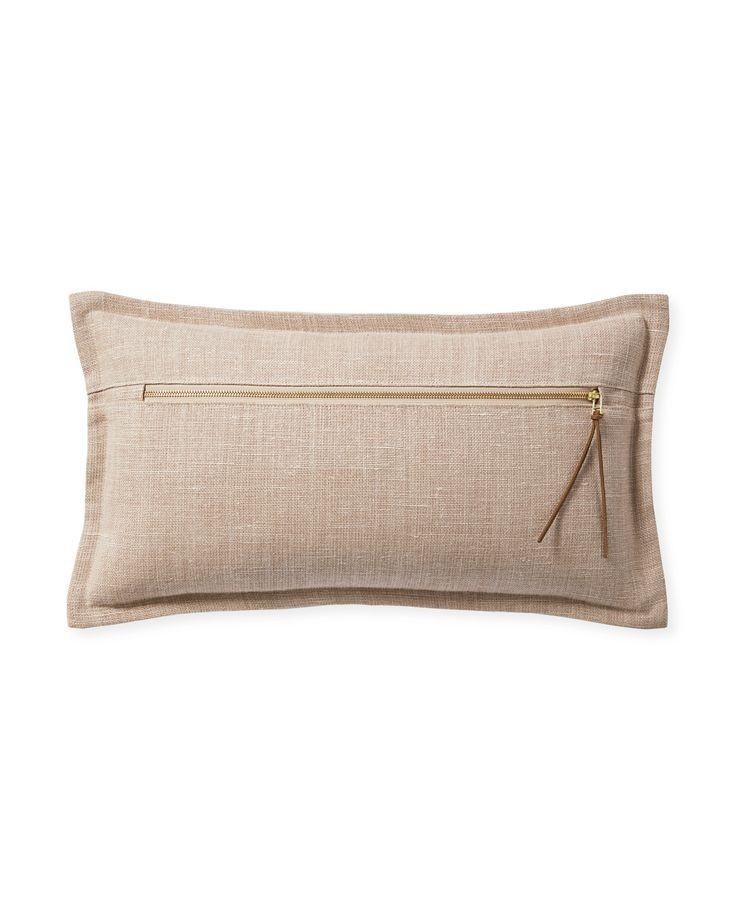 a beige pillow with zippers on it