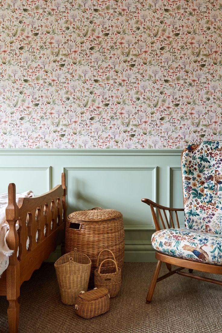 a bedroom with floral wallpaper and wicker basket on the floor next to a bed