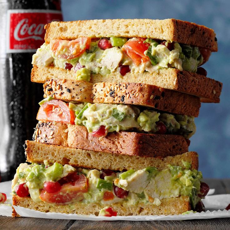 a stack of sandwiches sitting on top of a white plate