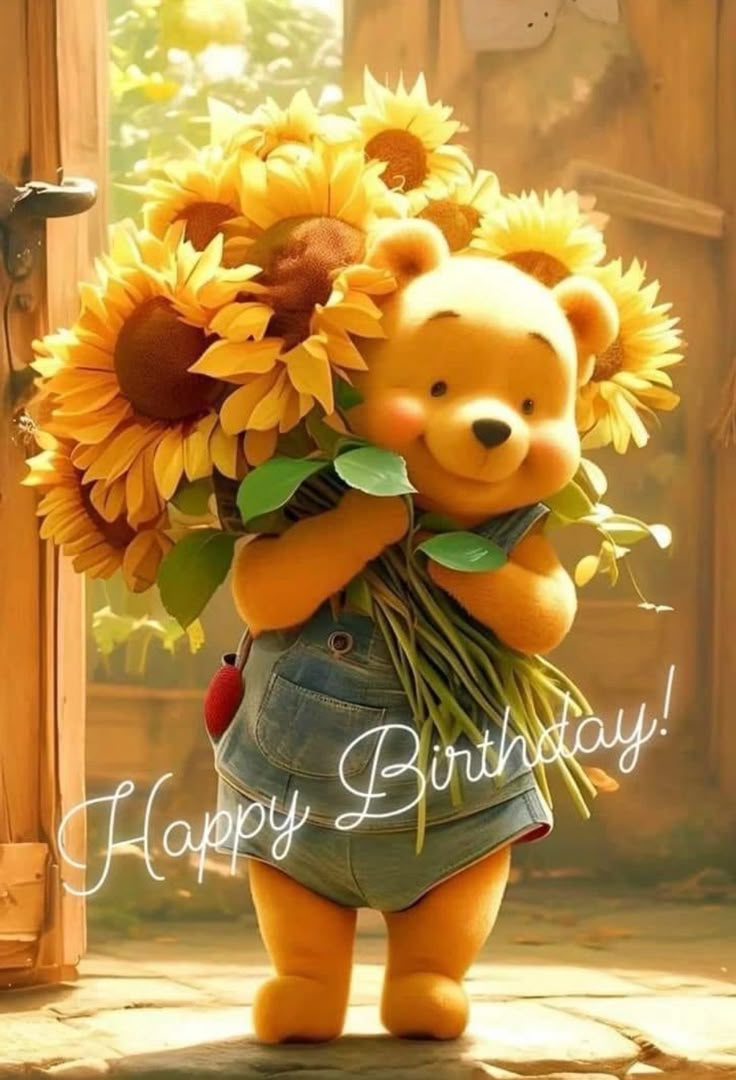 a teddy bear holding sunflowers in its arms