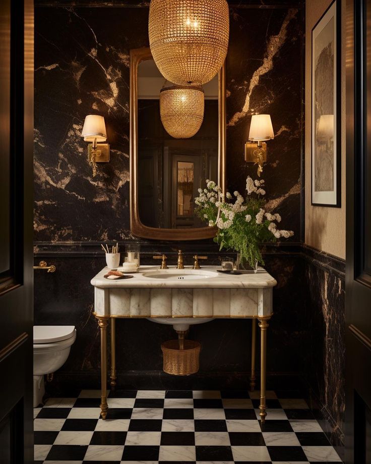 a bathroom with black and white checkered flooring, chandelier above the sink