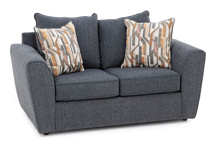 a gray couch with two pillows on it's back and the arms facing each other