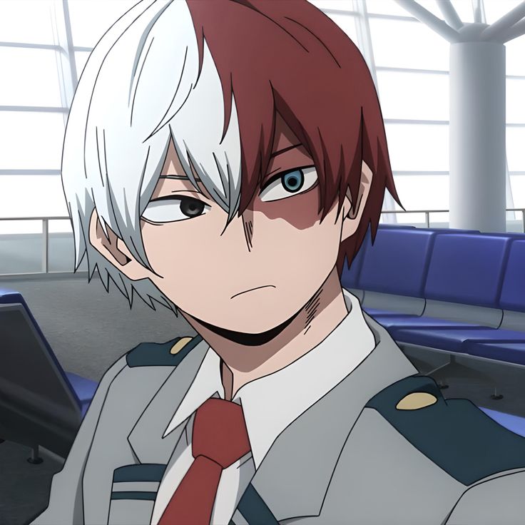 an anime character with red hair and white hair wearing a uniform in front of blue seats