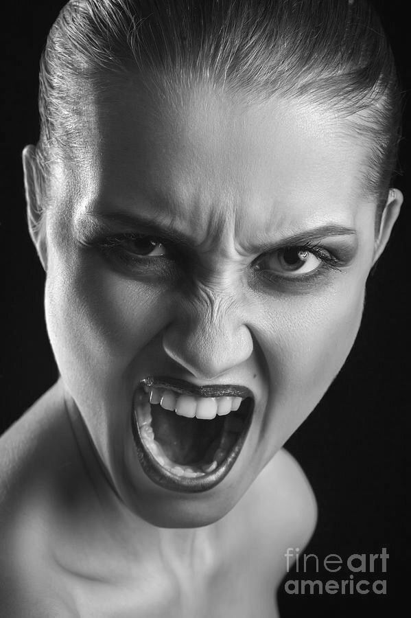 a woman with her mouth open and an evil look on her face