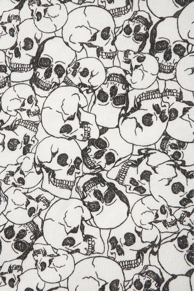 a bunch of skulls that are all over the placemat on this tablecloth is blue and white