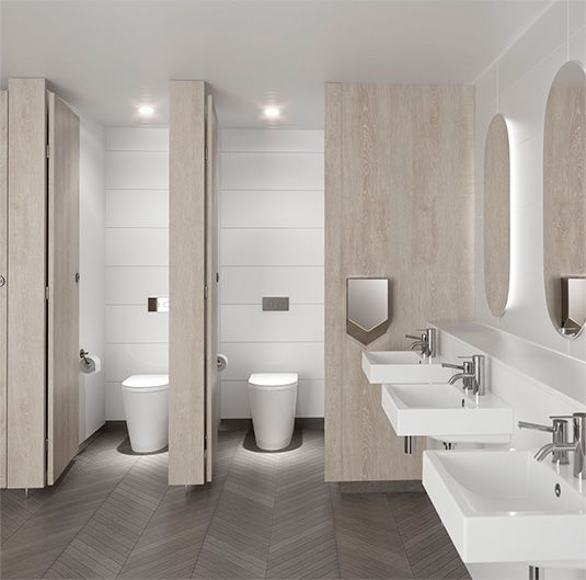 a modern bathroom with two sinks and three mirrors on the wall, along with toilet and bidet