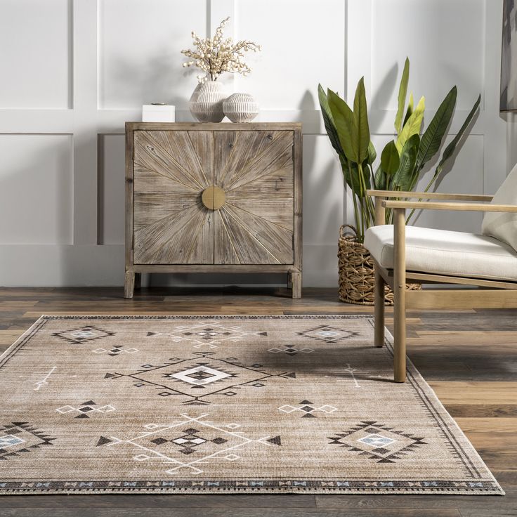 a living room with a rug, chair and potted plant on the sideboard